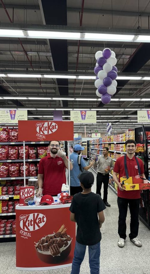 Brand ambassadors running a product sampling stand in-store